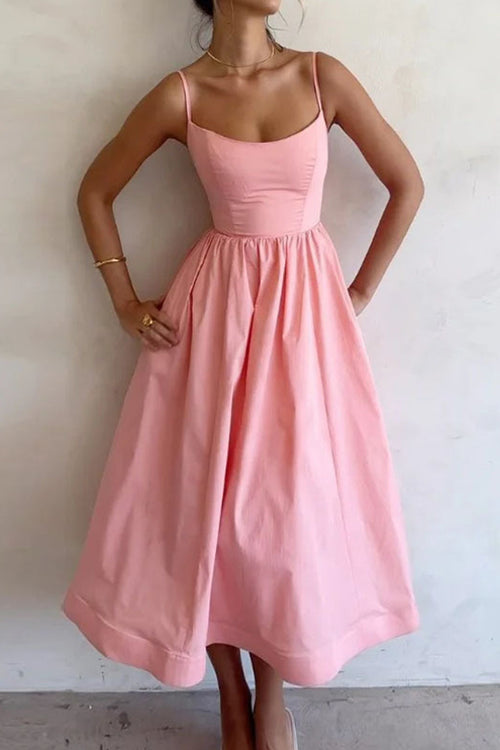 Pink midi dress with thin straps, fitted bodice, and gathered skirt at waist