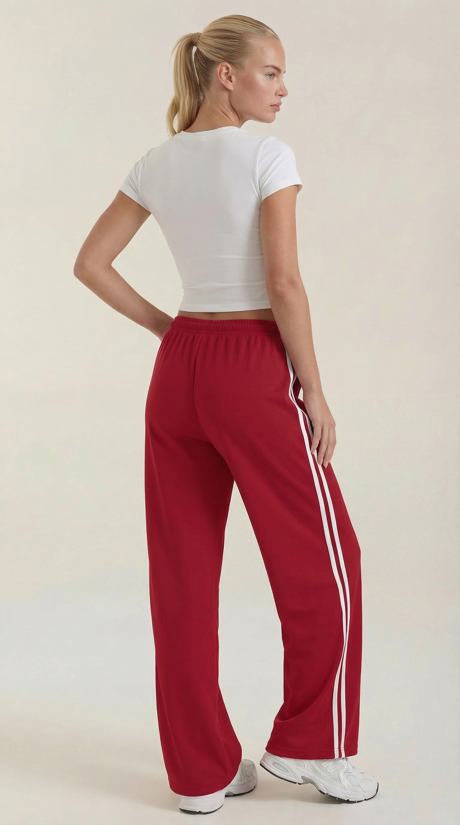 Red wide-leg track pants with white side stripes and drawstring waist