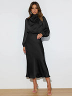 Black satin cowl neck midi dress with long sleeves and draped neckline