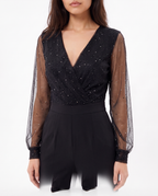 Black V-neck wrap-style bodice with sheer dotted sleeves