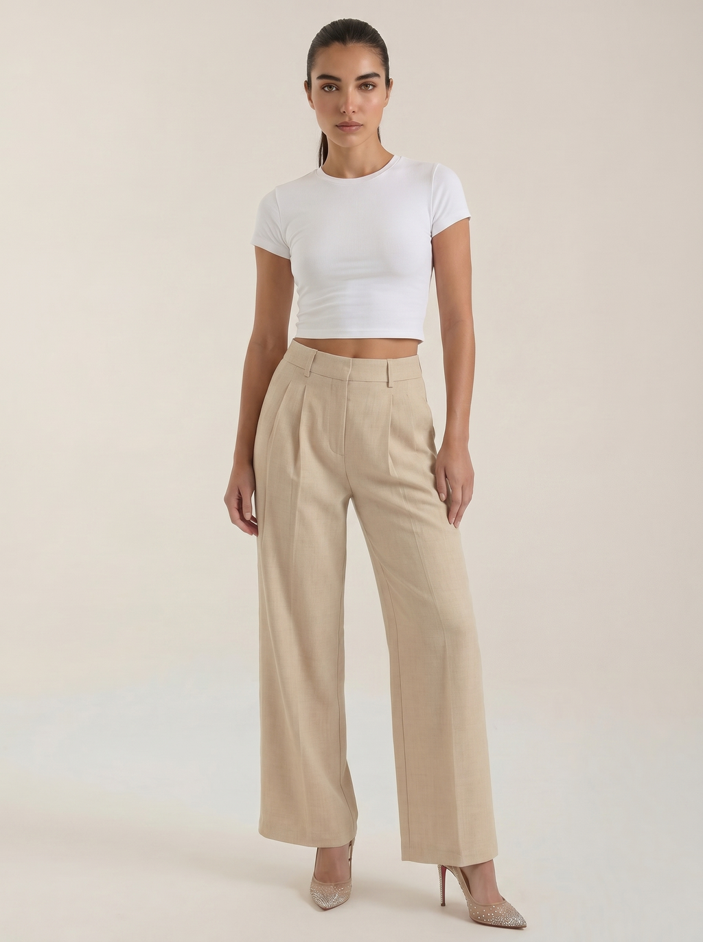 Women’s high-rise pleated wide-leg pants in beige, full length, zip front.