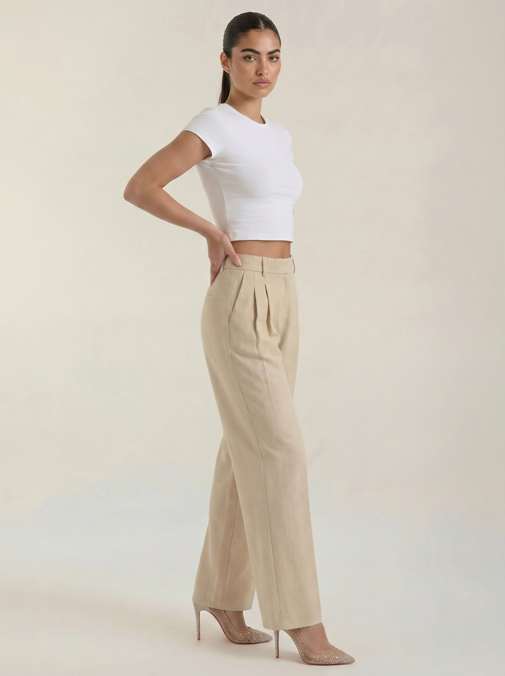 Women’s high-rise pleated wide-leg pants in beige with straight wide legs.