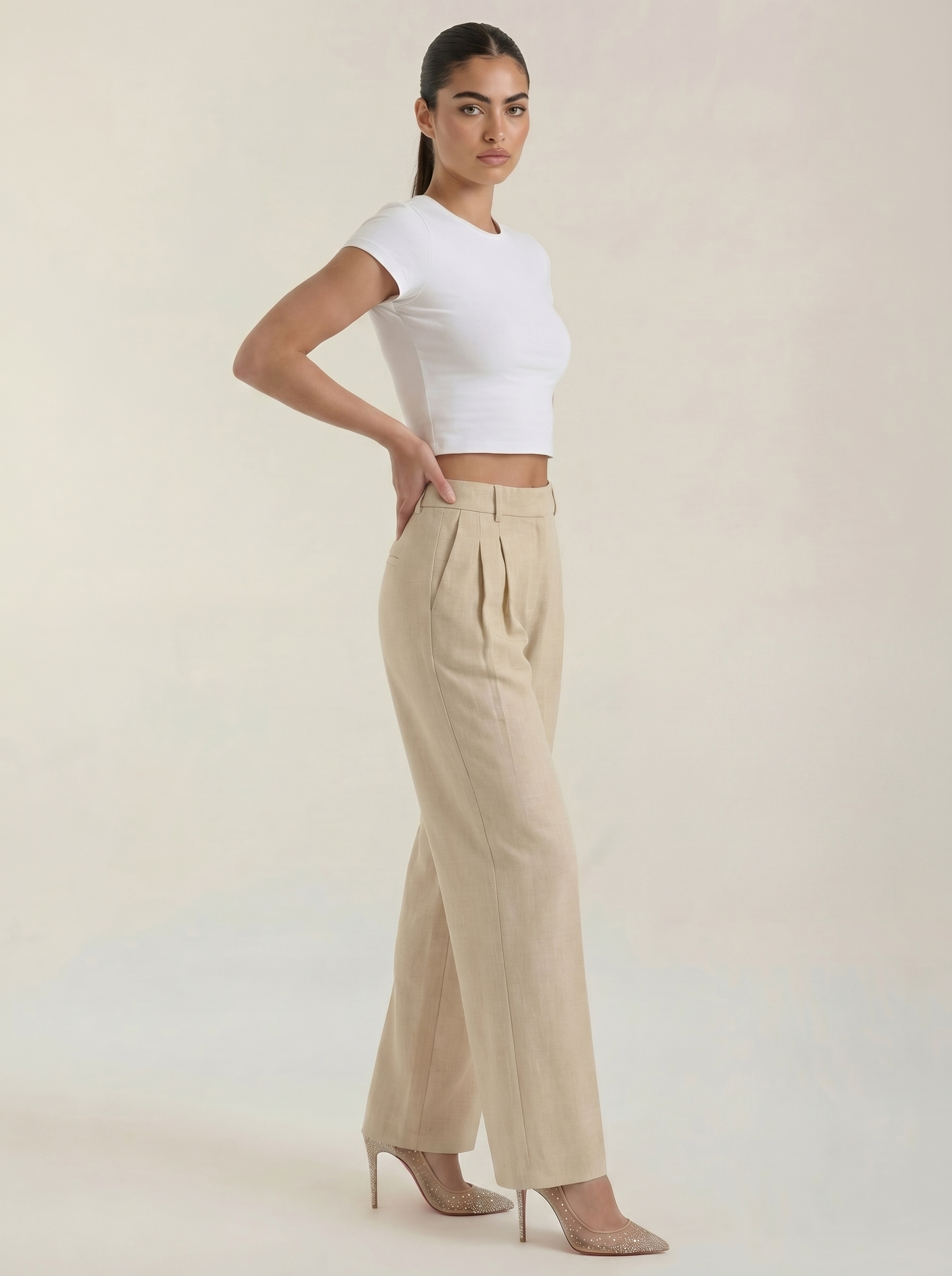 Women’s high-rise pleated wide-leg pants in beige with straight wide legs.