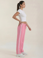 Women's pink wide-leg track pants with drawstring elastic waist and vertical side stripes.