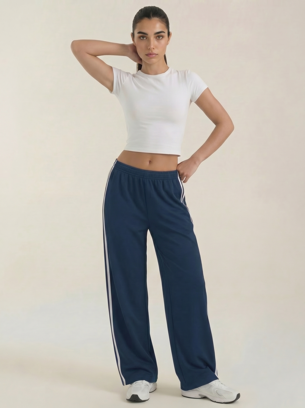 Navy blue wide-leg track pants with white side stripes and drawstring waist