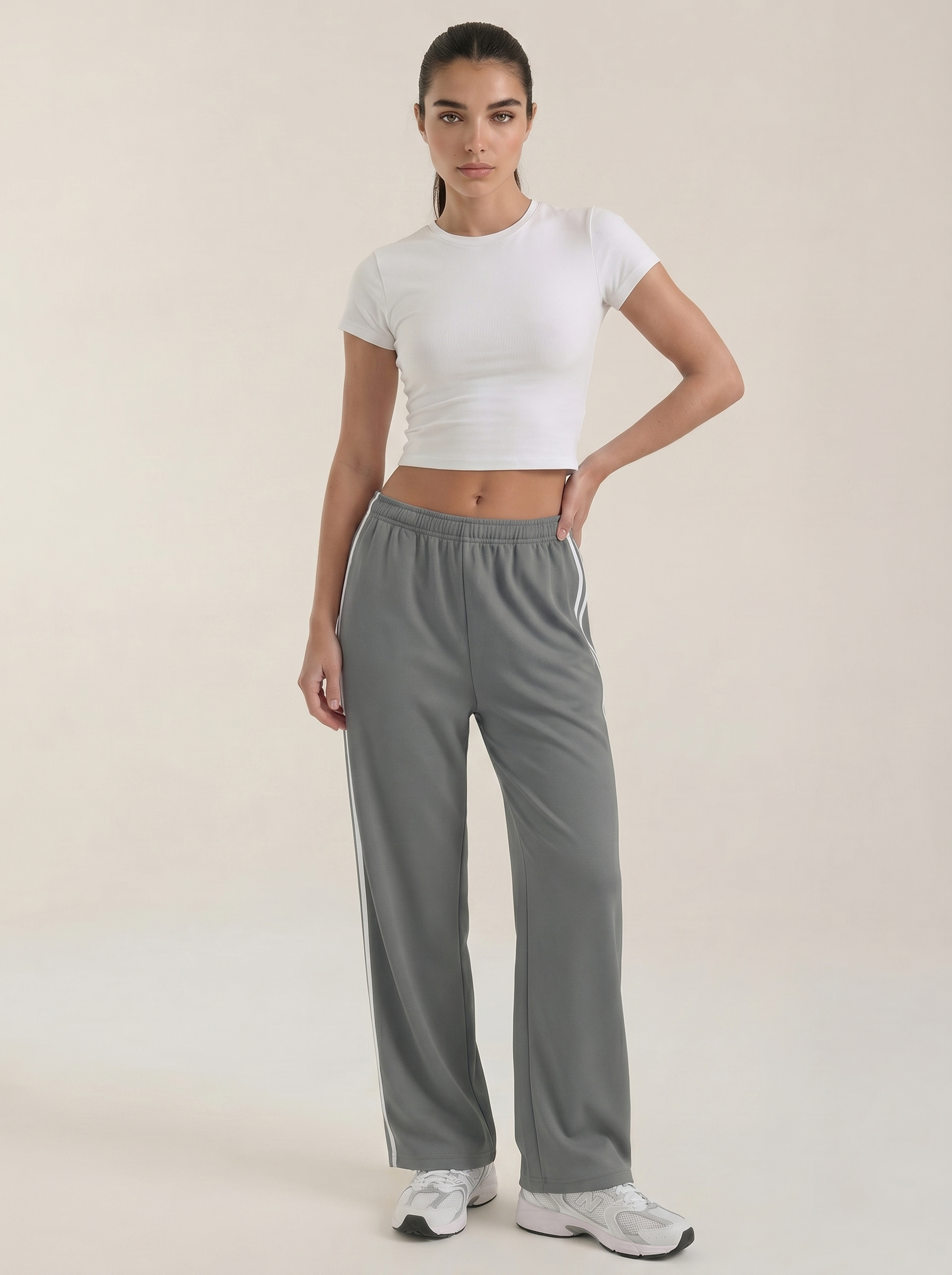 Gray wide-leg track pants with white side stripes and elastic drawstring waistband