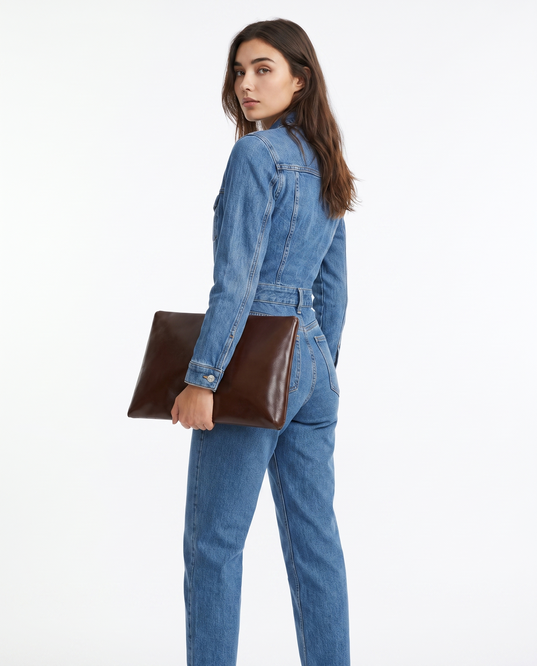 Blue denim jumpsuit side view with chest flap pockets, long sleeves, belted waist